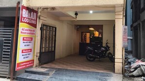 A two-story building with a sign for Balaji Lodging advertising AC and Non AC rooms. - Balaji Lodging  (Hinjawadi)