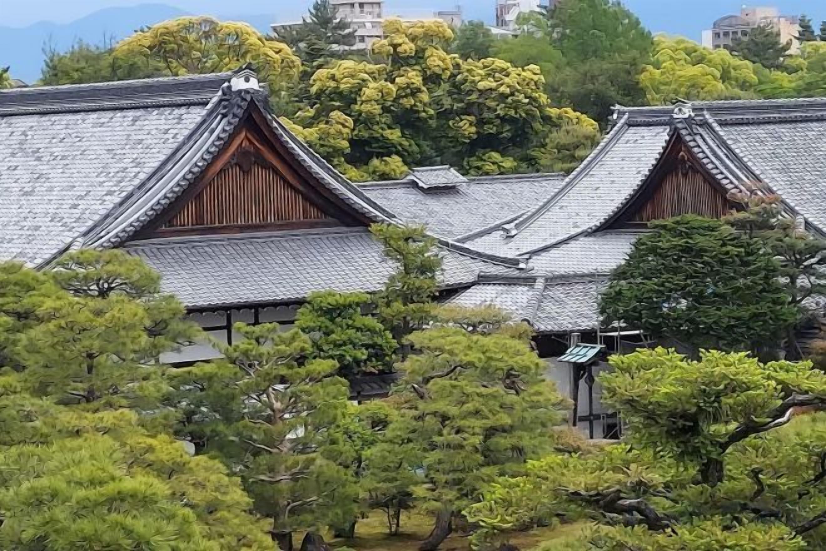 A traditional Japanese building with a tiled roof and wooden structures.