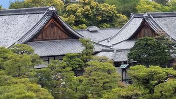 A traditional Japanese building with a tiled roof and wooden structures.