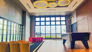 A spacious room with large windows, a modern desk, and a unique chair design. - Sunset Lake View at M-Luna Kepong by HCK (Kuala Lumpur)