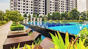 A swimming pool surrounded by lush greenery and tall residential buildings. - Sunset Lake View at M-Luna Kepong by HCK (Kuala Lumpur)