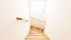 A staircase with a handrail leading to a window. - MoonLight inn Free parking (Dazaifu)