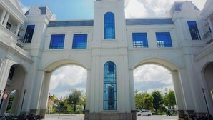A large white building with multiple arched entrances and a central tower. - HUYNH's HOUSE 4 Bedroom Apartment (Phu Quoc Island)