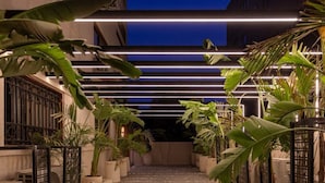 A pathway leading to a building entrance, flanked by potted plants and a modern light fixture. - 22 By Spacey (#55) | Studio in Maadi (Cairo)