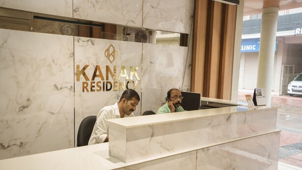 A reception desk with a marble finish and a logo that reads "KANAK RESIDENCY". - Kanak Residency Thalassary (Thalassery)