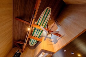 A wooden ceiling with a ceiling fan and a surfboard. - SOMEDAY (Onjuku)