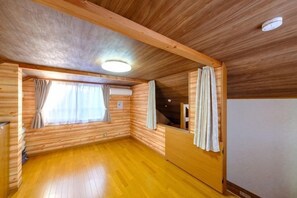 A room with wooden walls, a wooden ceiling, a window with curtains, and a wooden floor. - SOMEDAY (Onjuku)