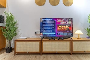 A television on a wooden stand with a plant to the left and a lamp to the right. - [NEW] Private Jacuzzi Near Velocity Mall MRT (Kuala Lumpur)