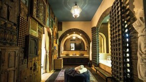 A luxurious bathroom with a large mirror, ornate wooden doors, and a unique wall design. - The Source Hotel Music & Spa (Marrakech)