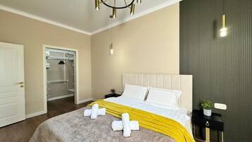 A hotel room with a bed, bedside table, and a closet.
