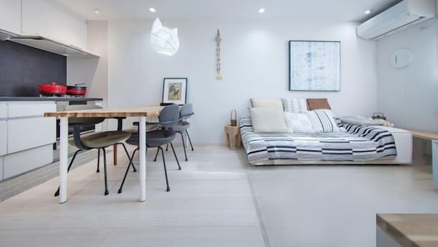 A modern, compact living space with a kitchenette, a dining area, and a bed. - Shinjuku Haramachi Sugar&Spice (Tokyo)