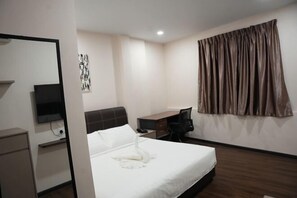 A hotel room with a bed, a desk, a chair, a TV, and a curtain. - Palz Empire Hotel (Temerloh)
