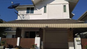 A two-story house with a satellite dish, a covered entrance, and a gated driveway. - Centraltesco/ NightSafari/4Bedroom Villa (Chiang Mai)