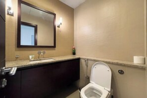 A bathroom with a sink, mirror, toilet, and a towel rack. - bnbme Luxury Seaview Retreat with Private Beach (Dubai)