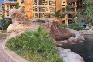 A landscaped area with a rock formation, a small water feature, and a pool. - bnbme Luxury Seaview Retreat with Private Beach (Dubai)