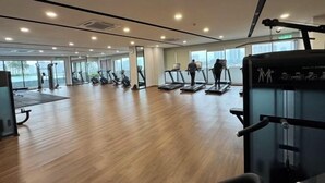 A spacious gym with multiple treadmills, a rowing machine, and a weight bench. - Elegant 3-Bedroom Fully Air-Con @ Vista Sentul (Kuala Lumpur)