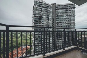 A balcony with a metal railing overlooking a high-rise building. - Molek Little Joy Studio 4pax Bathtub with Balcony (Plentong)