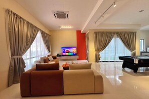 A modern living room with a sofa, a flat-screen TV, and a pool table. - Happiness Stay (20 Pax) With Karaoke, Snooker, Mahjong Table (Ipoh)