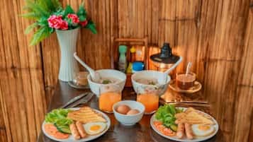 Een ontbijt met twee borden eten, een kom soep en een glas sap.