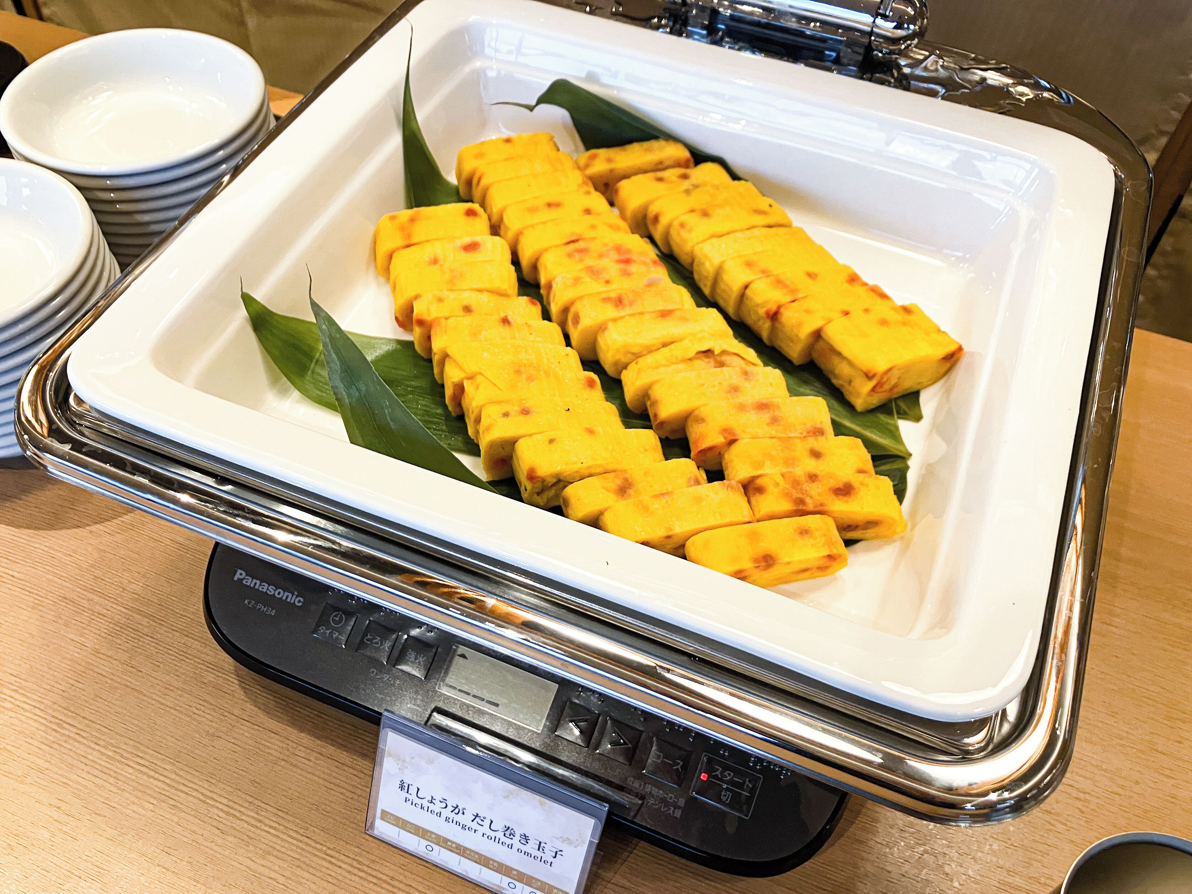 A white tray with yellow food items on a table.