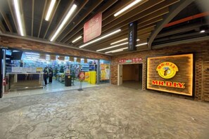 A spacious indoor area with a polished marble floor, a prominent MRDIY sign, and a storefront with various items on display. - Nostalgia Arcoris #163 #Hyatt #MontKiara (Kuala Lumpur)