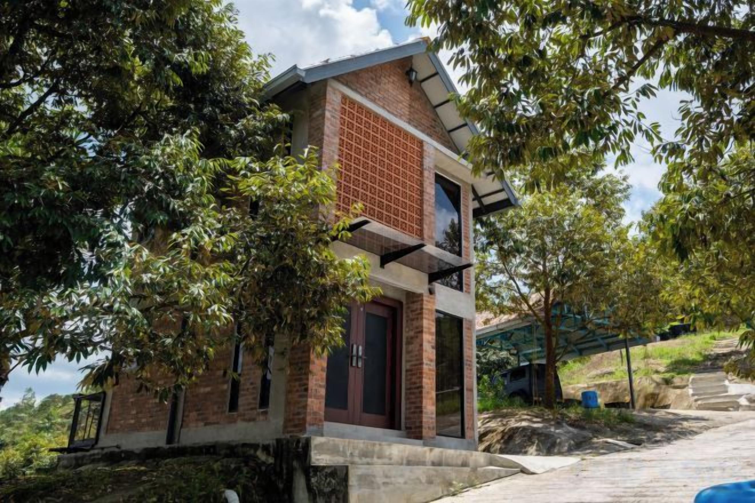 A small, single-story building with a brick facade, a flat roof, and a door.