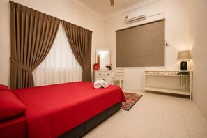 A hotel room with a bed, a bedside table, a mirror, a TV, and a window with curtains. - Batu Pahat Sri Jaya Villa 4BR 18pax (Simpang Kanan)