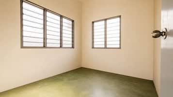 A room with two windows and a door.