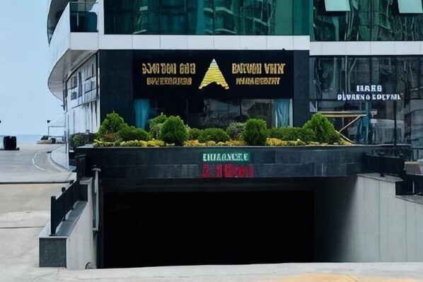 A modern building with a sign for 'BARTON VIK' and 'EQUILANCE' visible. - Sea side apartment in "Batumi View" (Batumi)