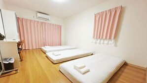 A room with two beds, a desk, a chair, and a wardrobe. - Guesthouse Atelier Ten (Osaka)