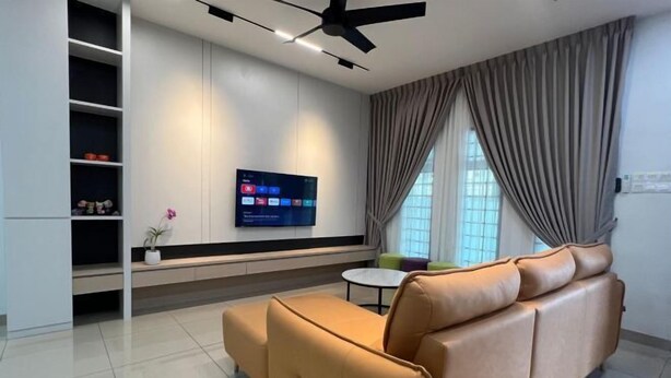 A modern living room with a sofa, a TV mounted on the wall, and a ceiling fan. - 5 min to AeonBig , Old Street, BP Mall & D Garden (Simpang Kanan)