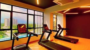 A gym with treadmills and a stationary bike, large windows with a city view, and an air conditioning unit on the ceiling. - FZ Homestay @ Putrajaya P5 : Luxury & scenic stay (Putrajaya)