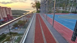 Een overzicht van een sportfaciliteit met een atletiekbaan en een rode loper.
