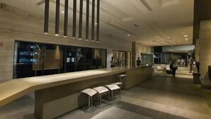 A modern lobby with a long reception desk, bar stools, and a glass partition. - The Elements @ Ampang (Kuala Lumpur)