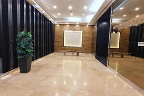 A lobby with a marble floor, a potted plant, and a bench. - The Elements @ Ampang (Kuala Lumpur)