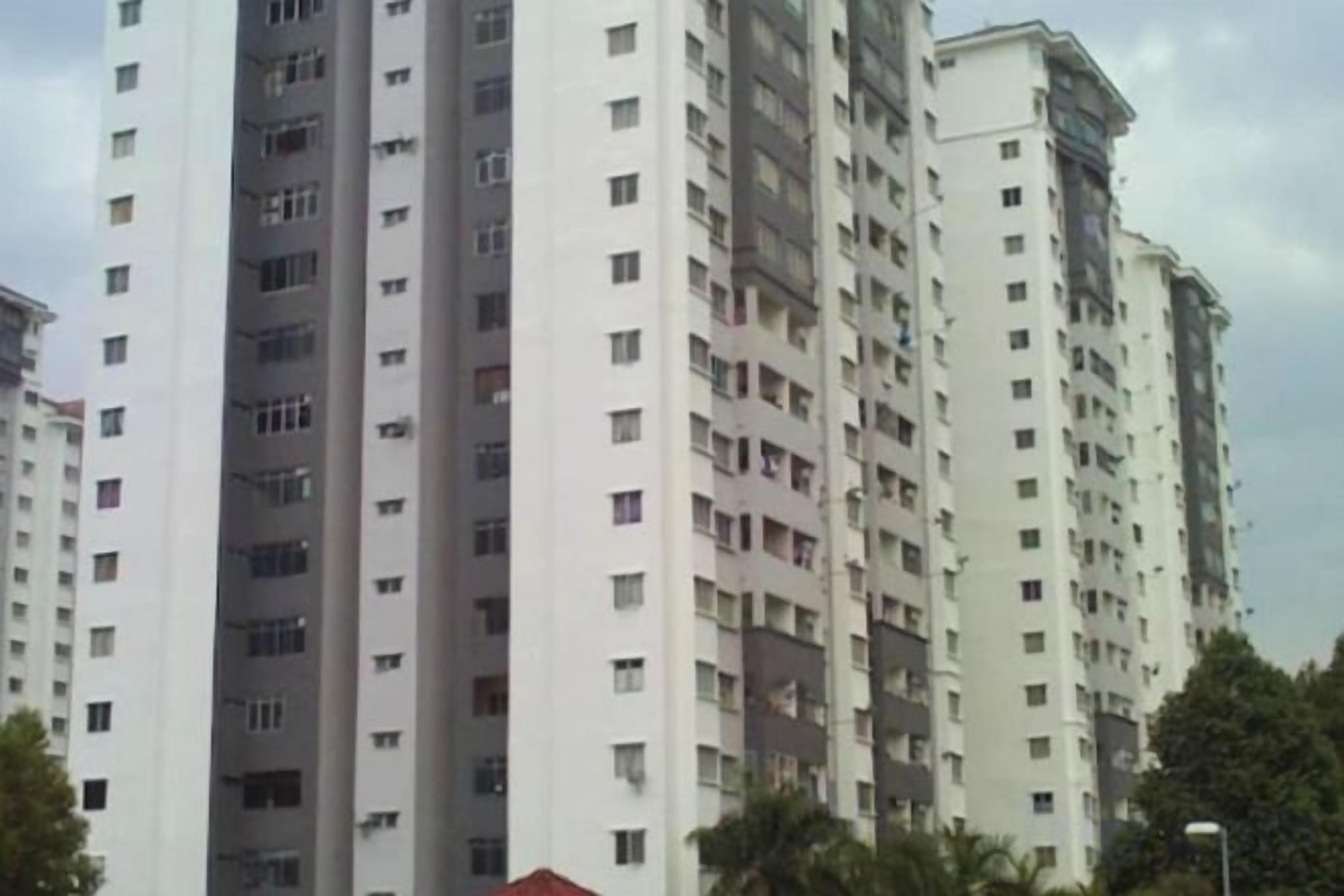 A high-rise residential building with multiple floors and balconies.