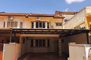A two-story building with a covered patio area, a central entrance, and a visible garage. - Seremban-Spacious-Lovely-Home-Bkt Chedang-S2-10R4B (Seremban)