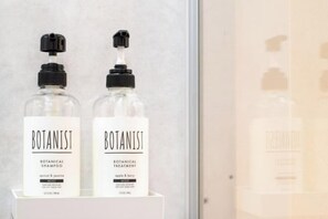 Two bottles of Botanist products on a white shelf. - Ranjatai Premium (Nara)