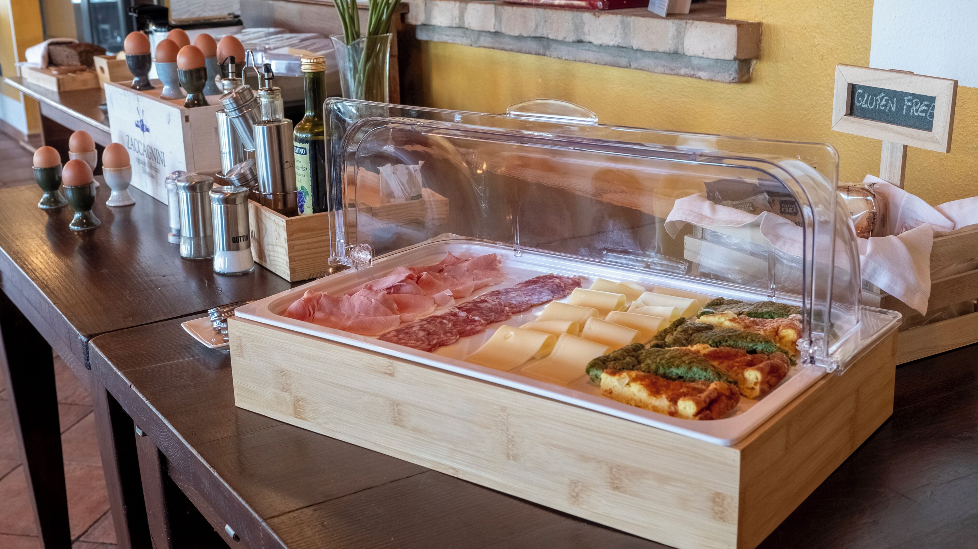 A buffet with various meats, cheeses, and pastries.