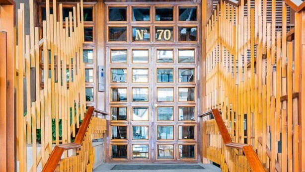 A wooden facade with a central door labeled "Nº 70" and a staircase leading up to it. - Heart of Madrid III Museums Theatres Sights (Madrid)