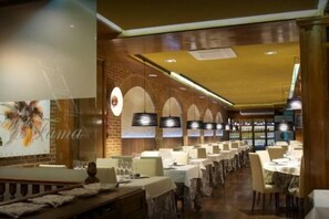 A restaurant with long tables, hanging pendant lights, and brick walls. - Heart of Madrid III Museums Theatres Sights (Madrid)