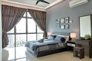 A modern bedroom with a bed, bedside tables, a desk, and a large window. - Delight Homestay Palazio (Tebrau)