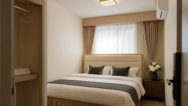 A neatly arranged bedroom with a bed, bedside table, and a wardrobe. - sakuranoyado (Tokyo)