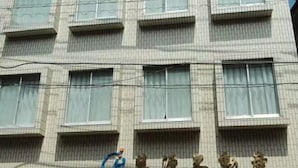 A building with multiple windows and a logo on the facade. - sakuranoyado (Tokyo)