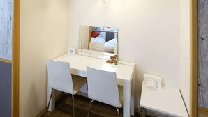 A small, white desk with two chairs, a mirror, and a small table with a tissue box. - Prosupa6 2F (Nagoya)