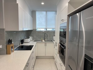 Private kitchen - Stylish 2-bed coastal apartment near beach & marina – perfect for relax or work. (Soldiers Point)