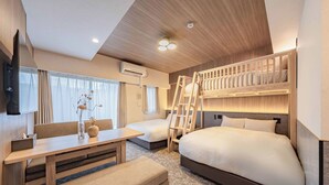 A modern hotel room with bunk beds, a desk, a chair, and a bedside table. - Apartment Hotel 11 Shinimamiya 3 (Osaka)