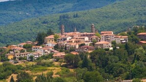 A hillside village with traditional architecture, including a church with a bell tower. - Apartment 29 Surrounded by Tranquility (Castel del Piano)