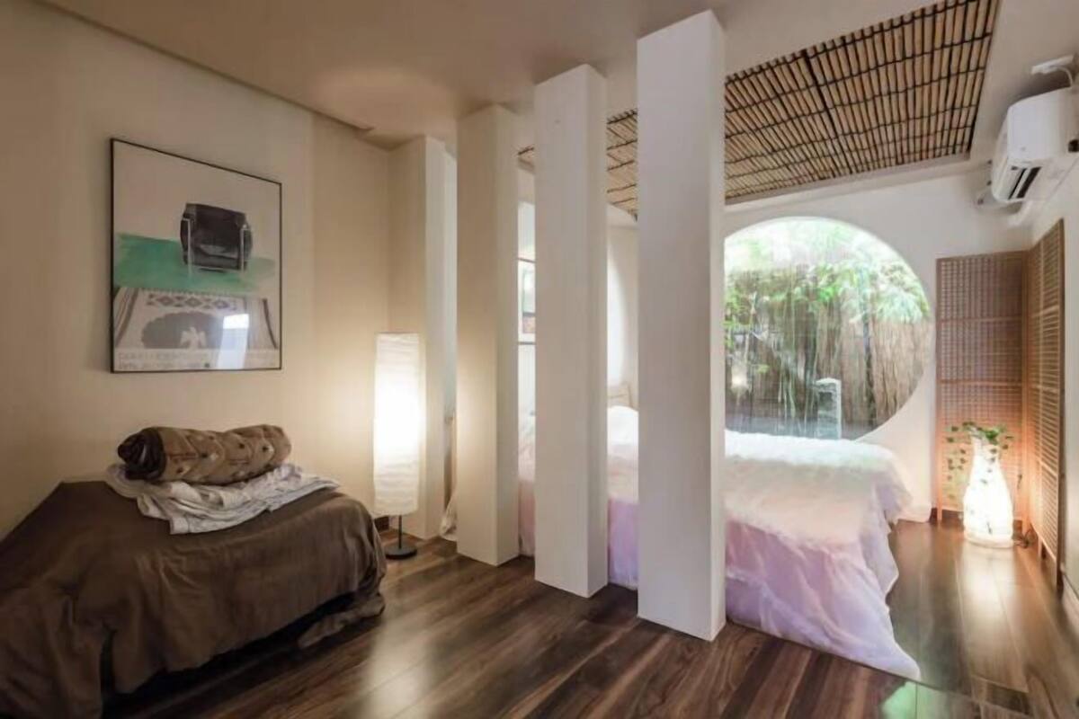 A room with a bed, a desk, and a window.