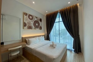 A modern hotel room with a bed, desk, and large window with curtains. - Oceanfront- Laman Green Villa, Port Dickson (Port Dickson)